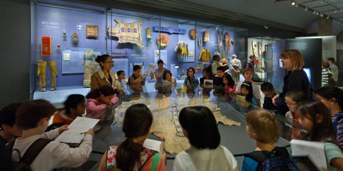 Children gather around exhibition case