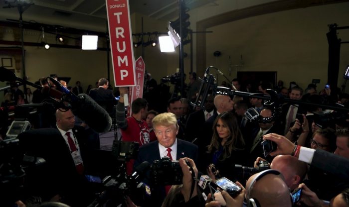 Donald and Melania Trump in scrum of reporters