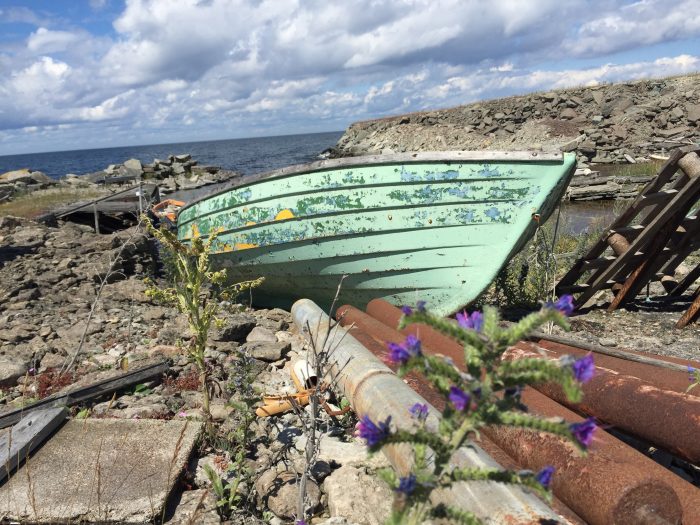 A weathered boat rests on the shore of Öland Island, Sweden.