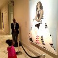 Little girl gazing ot Michelle Obama's portrait