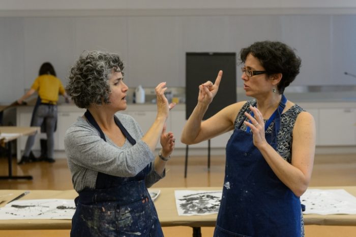 Two women signing