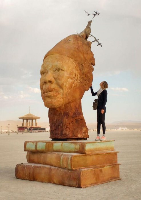 Sculpture of woman's head atop books