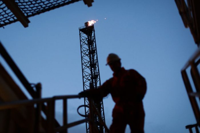 Silhouette of worker on oil rig