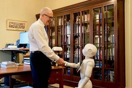 Skorton shakes hands with robot