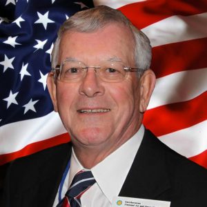 Portrait of Graham posed against American flag