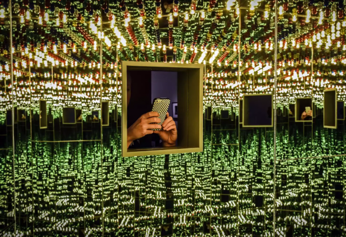 Cell phone reflected in mirrored exhibition