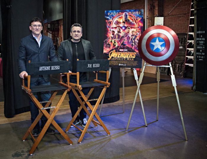 Russo brothers on set with director chairs and prop shield