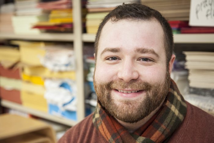 Close up of Lasnowski in front of shelves