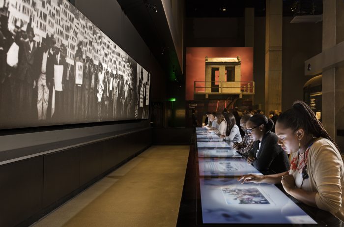 Visitors sit at long interactive counter