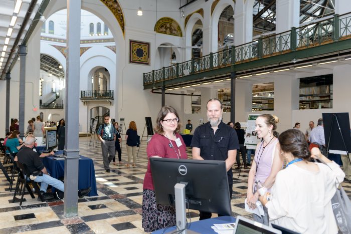 Visitors chat with presenters in Grand Hall