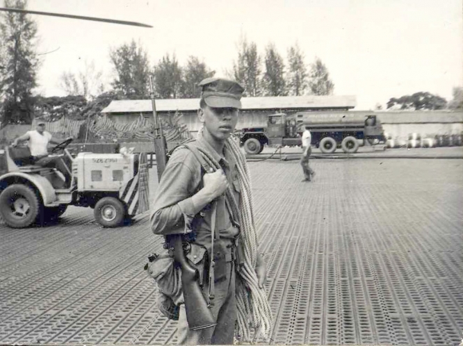 Young man in uniform gazes at camera