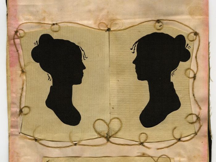 paper silhouettes of two women facing each other