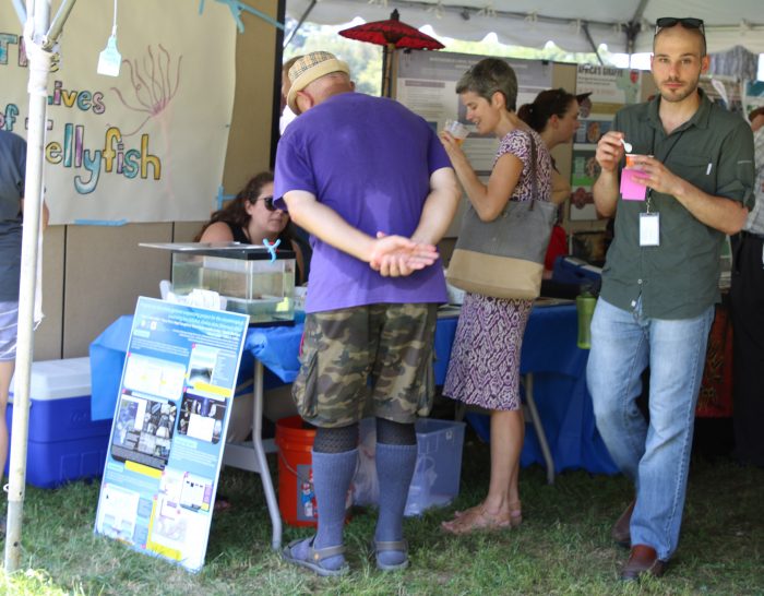 Group gathers around information table