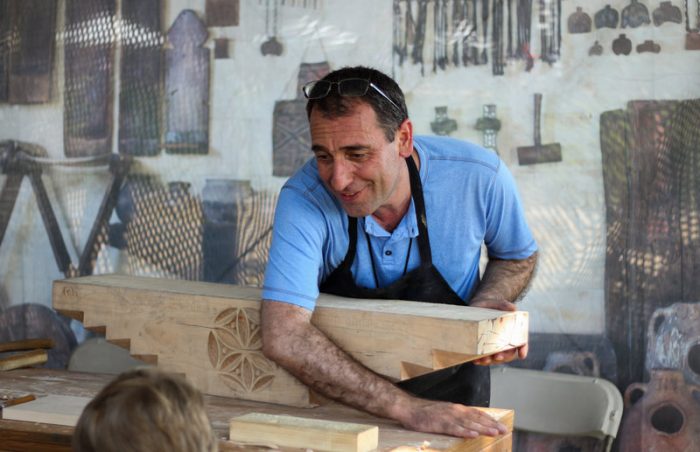 Man carving block of wood