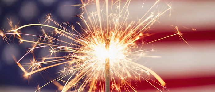 Sparkler with American flag in backgroun