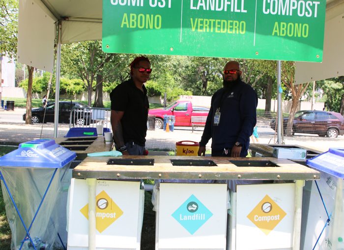 Two men manning recylcling booth