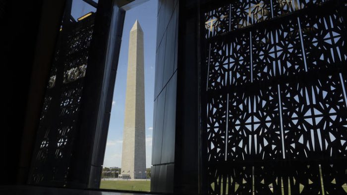 Washington monument framed by NMAAHC