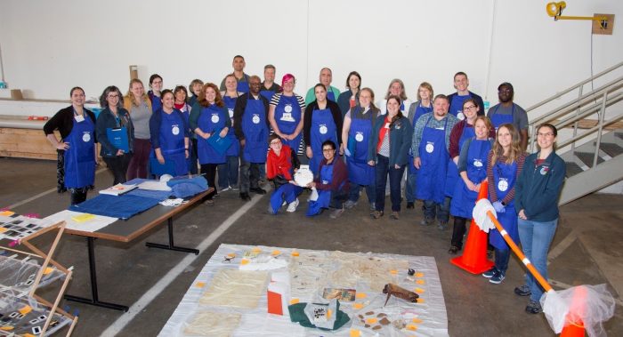 Gorup photo of participants in blue aprons