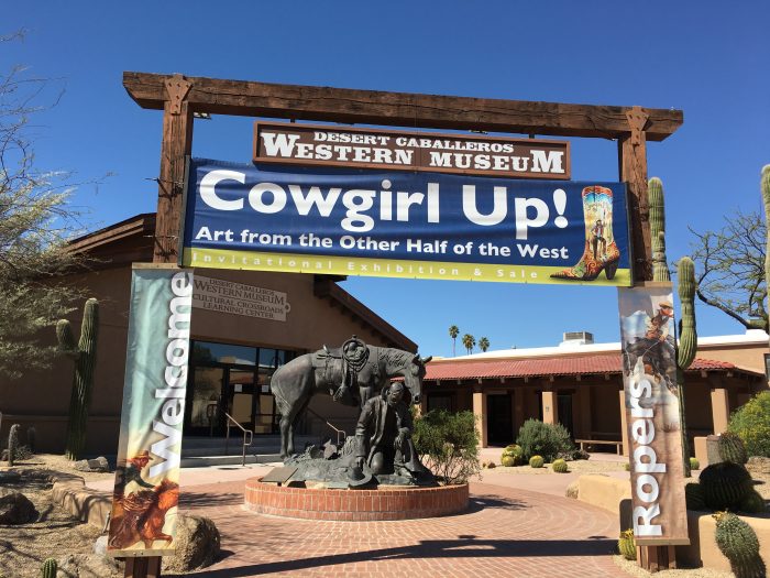 Museum entrance with banner for exhbition "Cowgirl up"