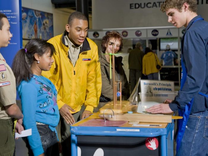 Family gathers around a demonstration station