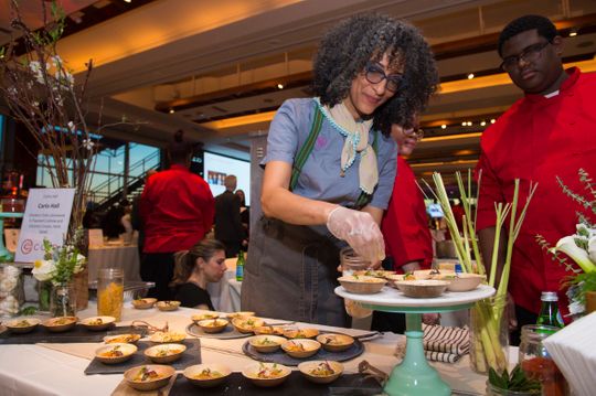 Chef Carla Hall plating food