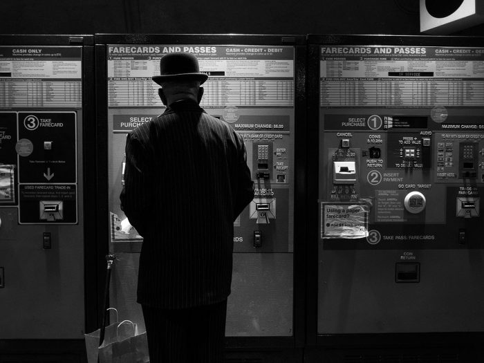 Man in hat buying Metro ticket