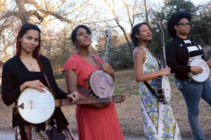 Four women performers with banjos