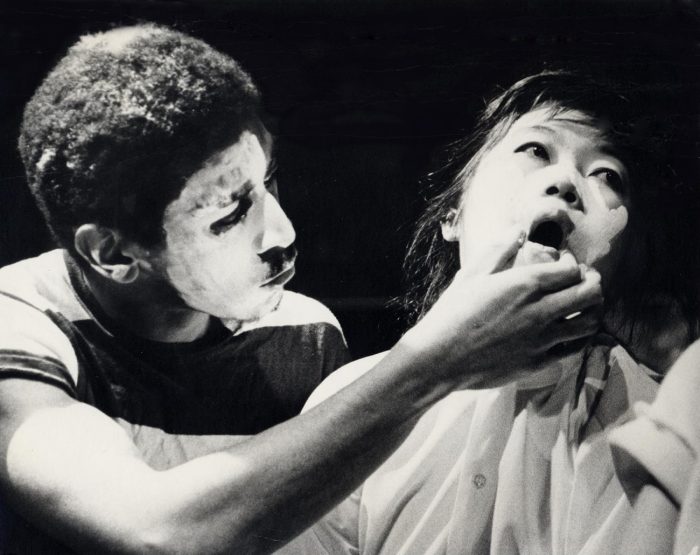 Still of Asian woman and Black man in whiteface