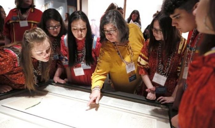 Young people looking at treaty display