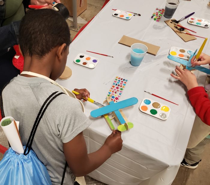 Children painting toy airplanes