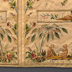 Detail of fabric embroidered with monkeys and palm trees