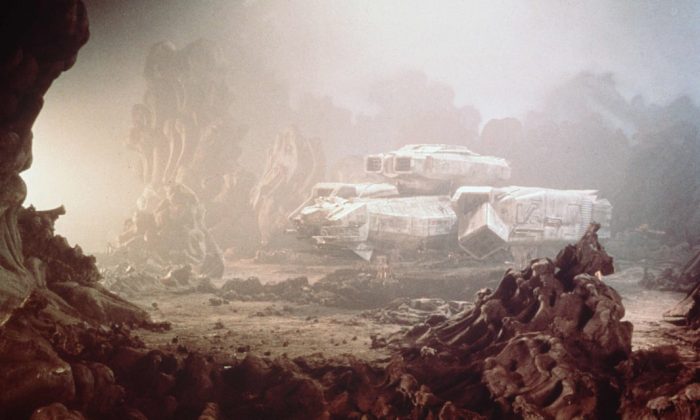 Film still showing mining vehicle on rocky planet