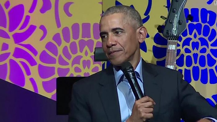 Obama with microphone at public event