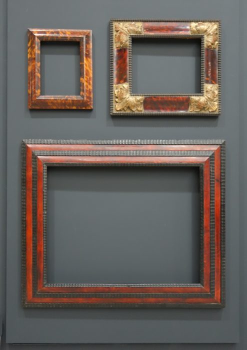 Empty frames on gray wall