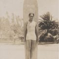 Duke posing with hand-carved longboard