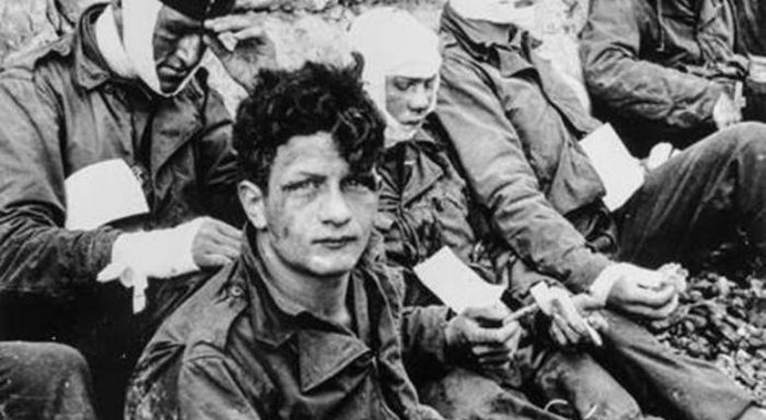 B&W photo of wounded soldiers, one looking directly into camera