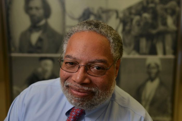 Lonnie Bunch in in front of exhibit case