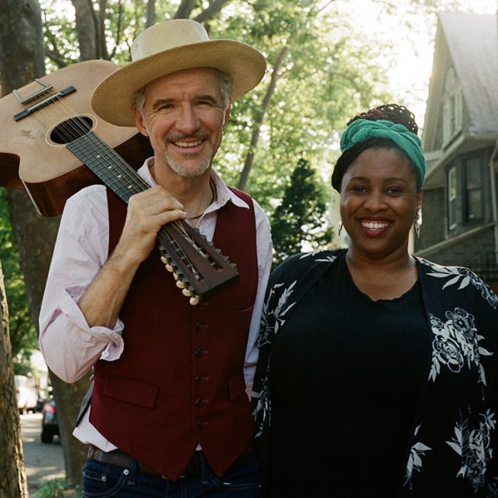 Man with guitar and smiling woman