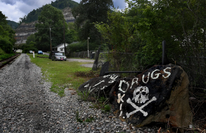 rural road with "No drugs" painted on rock