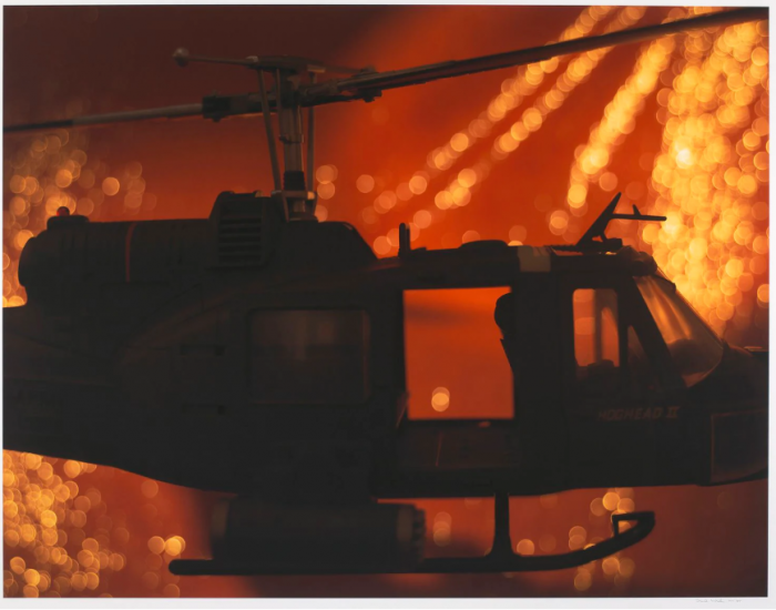 Helicopter silhouetted by fire