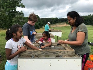 Young volunteers sifting for artifacts