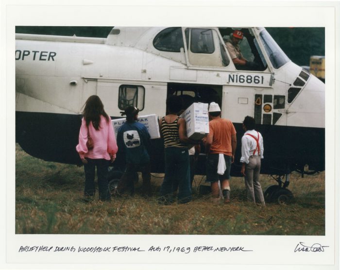 People loading helicopter