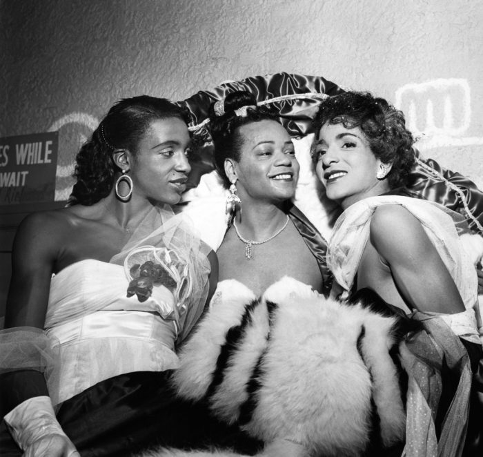 Three African American women dressed in finery