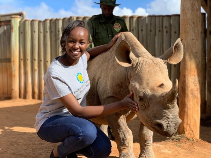 Woman in SCBI T shirt with young rhino