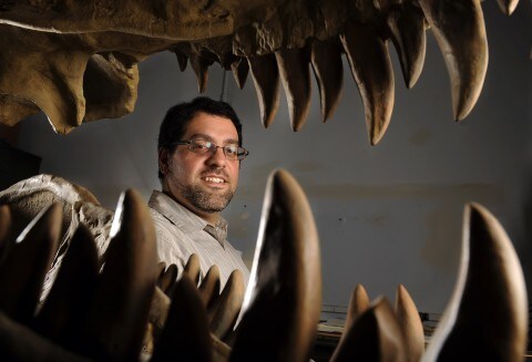 Matt Carrano framed by dinosaur teeth