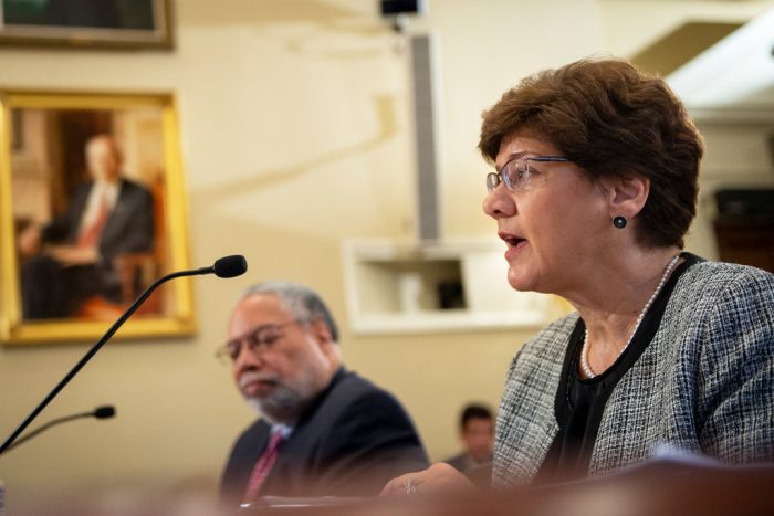 Congressional hearing with Cathy Helm in foreground, Lonnie Bunch in background