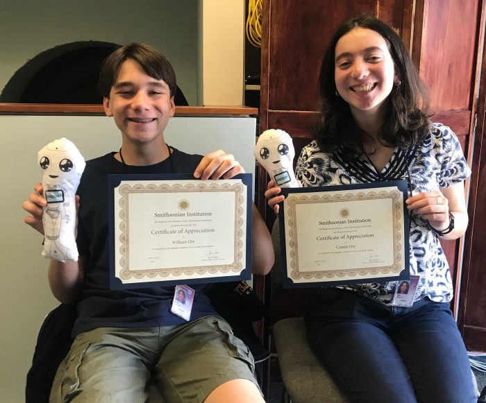 Brother and sister hold certificates