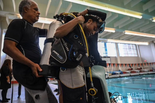 Student putting on diving gear