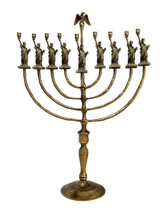 Brass menorah featuring eagle and statue replicas