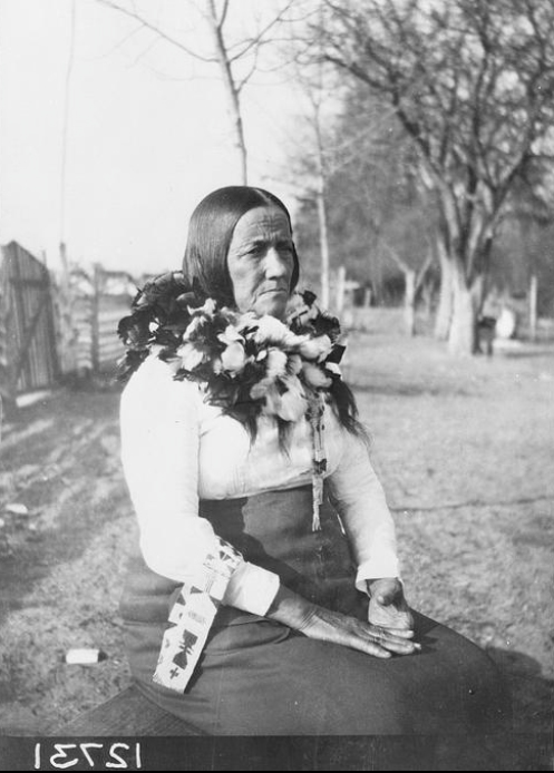 Native woman wearing scarf made of feathers